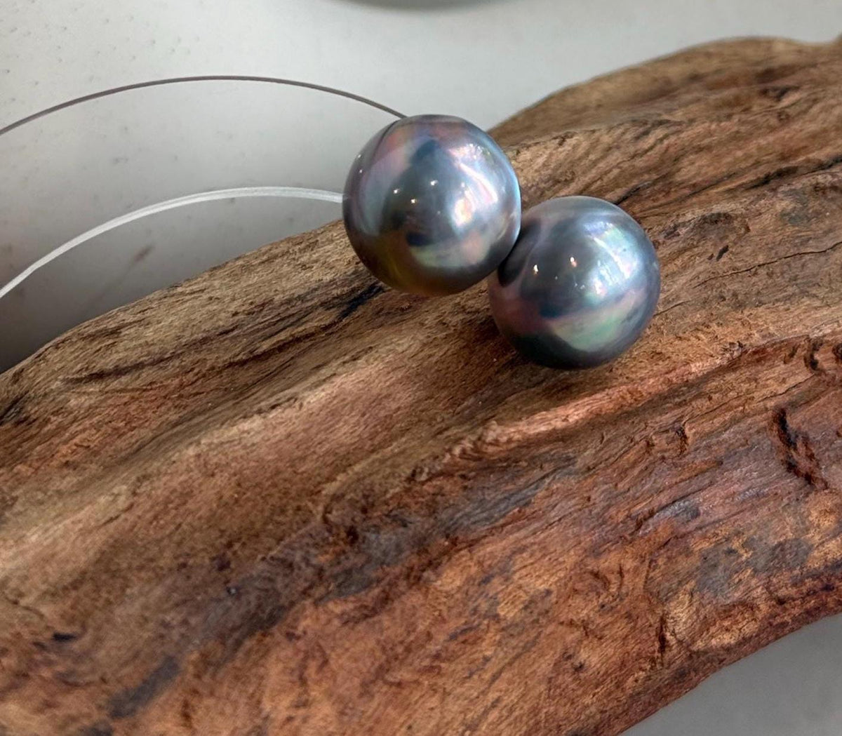 Genuine iridescent Mabe pearls paired with minimalist silver earring settings.