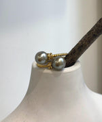 Double pearl statement ring with reflective Tahitian pearls in warm gray and taupe hues.