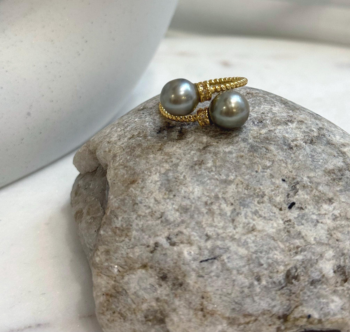 Double Tahitian pearl ring highlighting soft taupe coloring and reflective pearl surfaces.