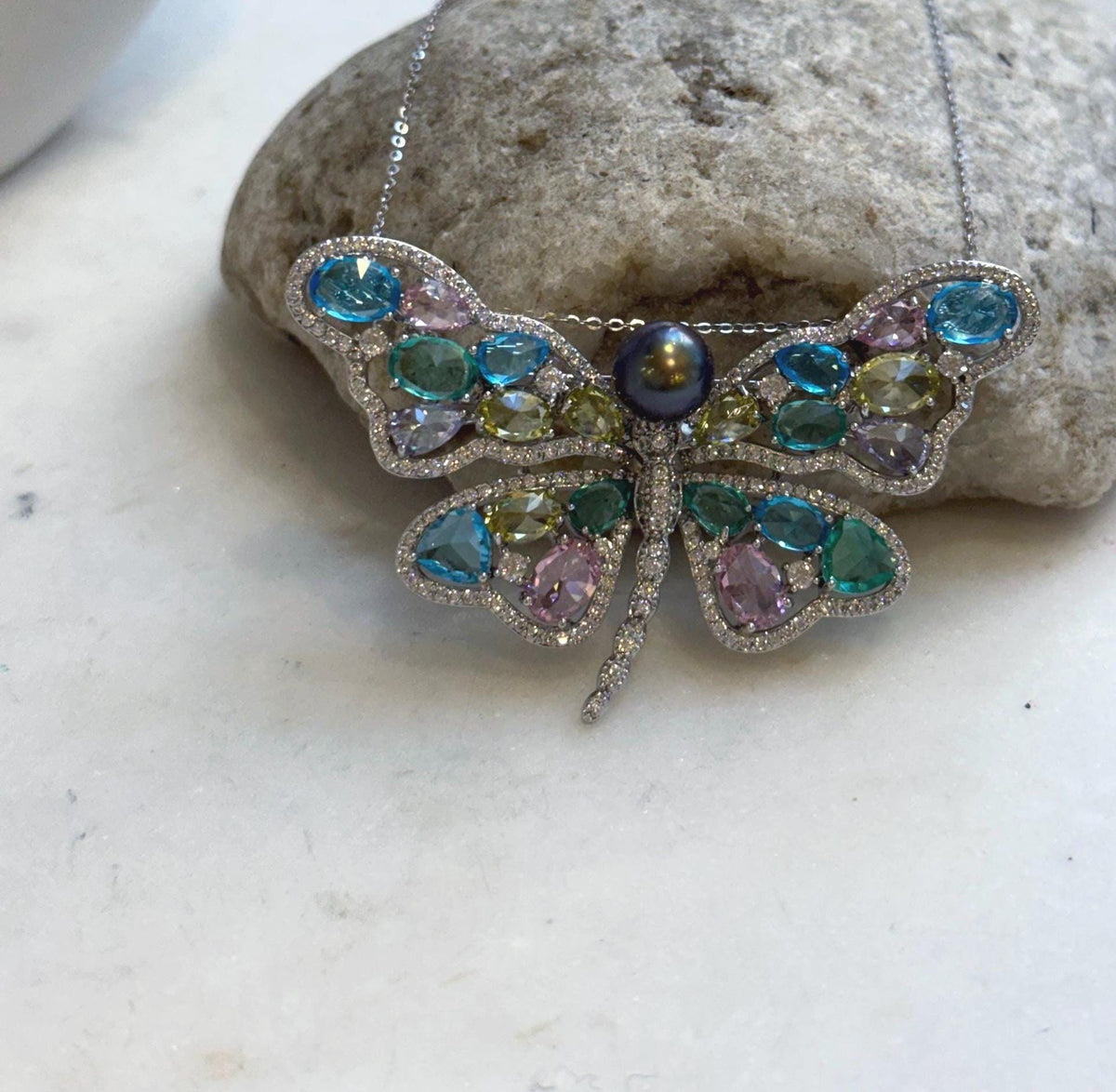 Butterfly jewelry featuring a genuine saltwater Tahitian pearl.