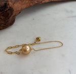 South Sea pearl bracelet on a pale background.