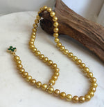 Golden Edison pearls with a luminous sheen.