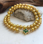 Classic golden pearl necklace with individually knotted pearls.