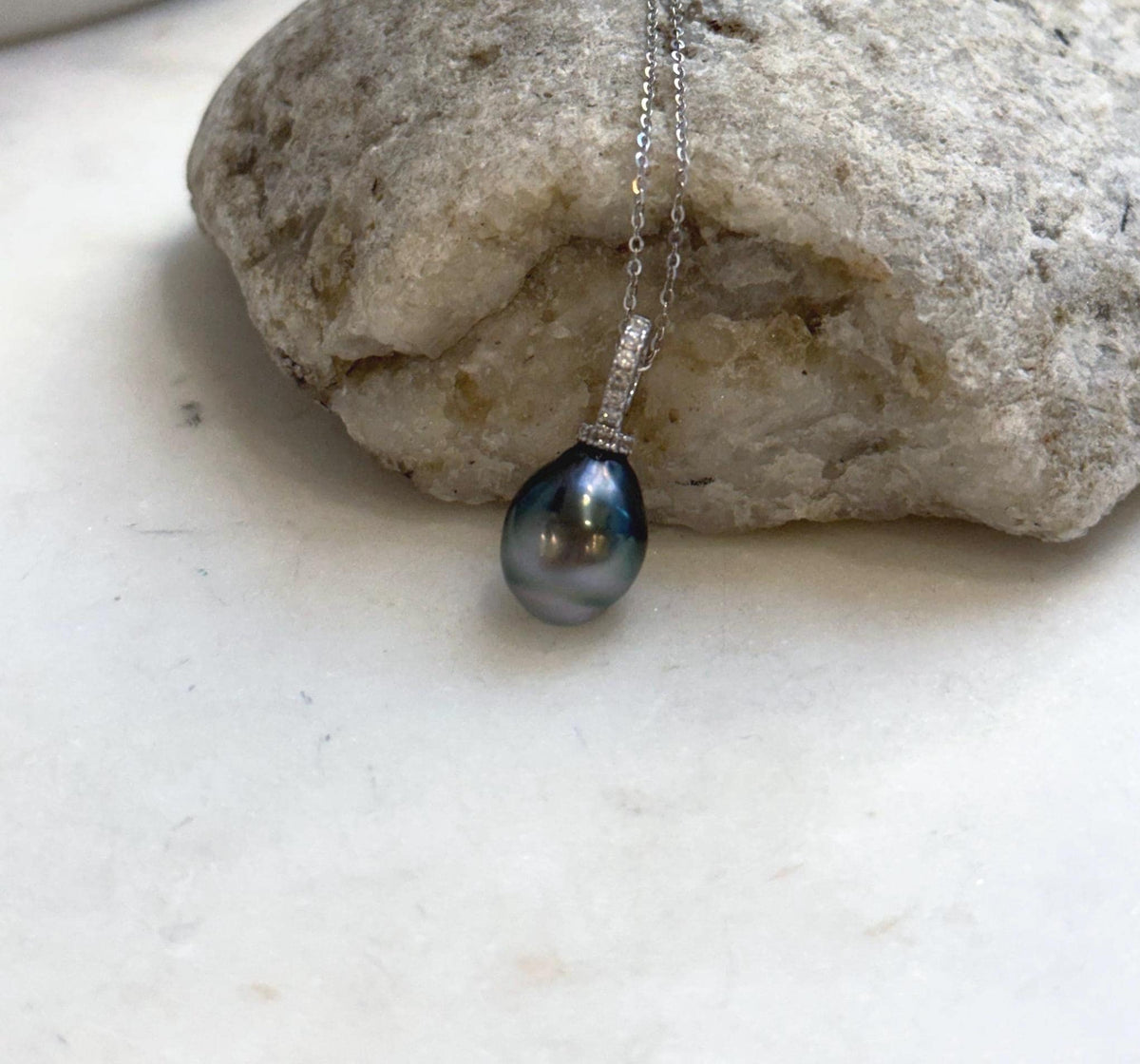 Hunter green Tahitian pearl with silvery overtones in a crystal-accented pendant.