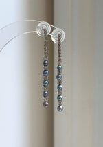 Peacock freshwater pearl drop earrings with sparkling crystal accents.
