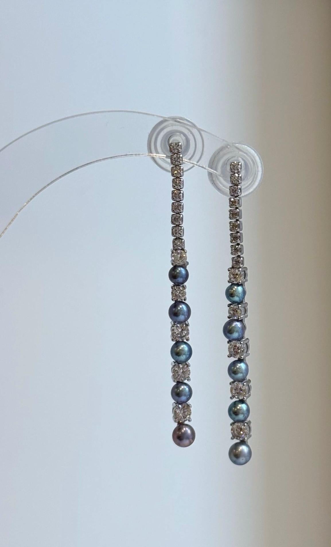 Freshwater pearl earrings showing blue, green, and purple tones.