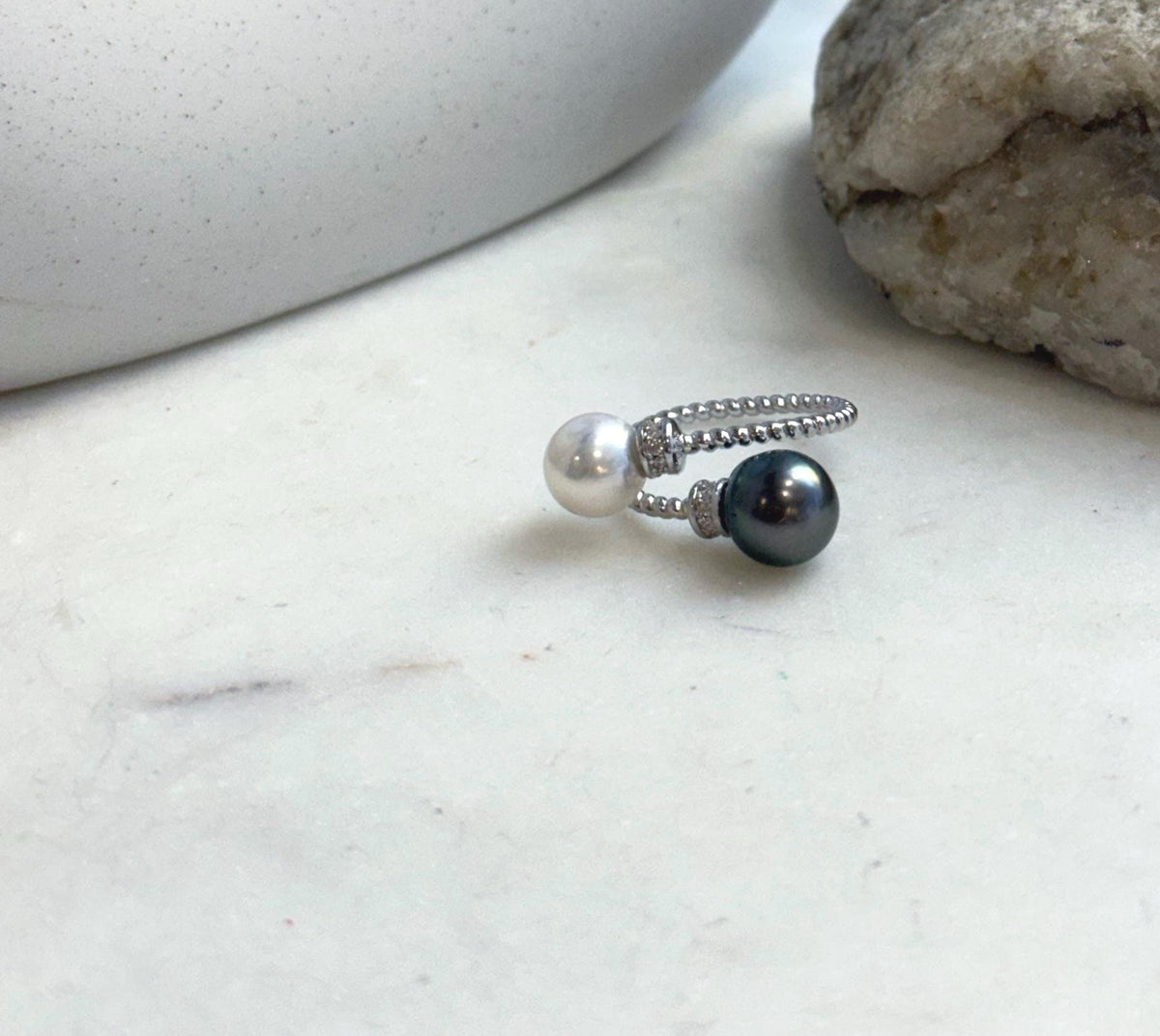 Minimalist sterling silver ring showcasing two genuine pearls with mirror luster.