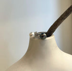 Sterling silver pearl ring highlighting the reflective surfaces of two genuine pearls.