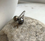 Sterling silver ring highlighting the reflective luster of two Tahitian pearls.