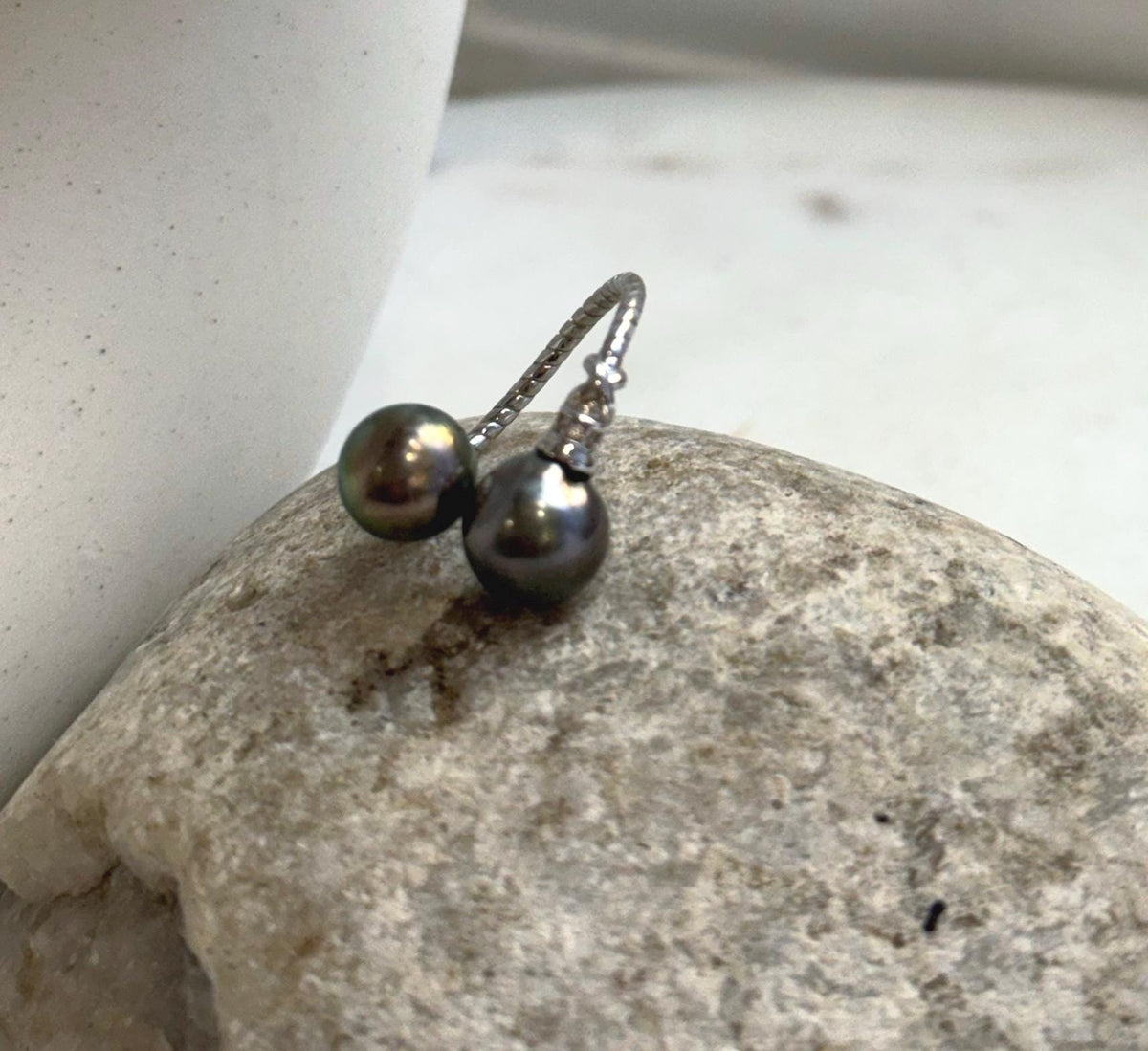 Sterling silver ring highlighting the reflective luster of two Tahitian pearls.
