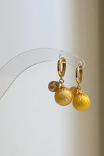 Golden carved South Sea pearls paired with freshwater pearls.