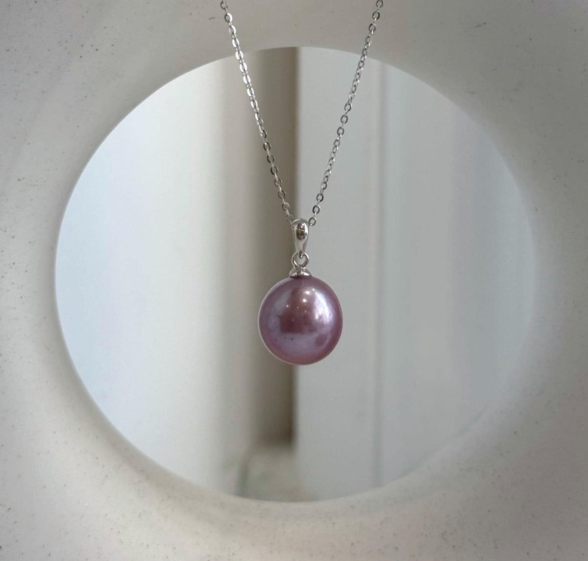 Matching Edison pearl stud earrings with glossy lavender tones.