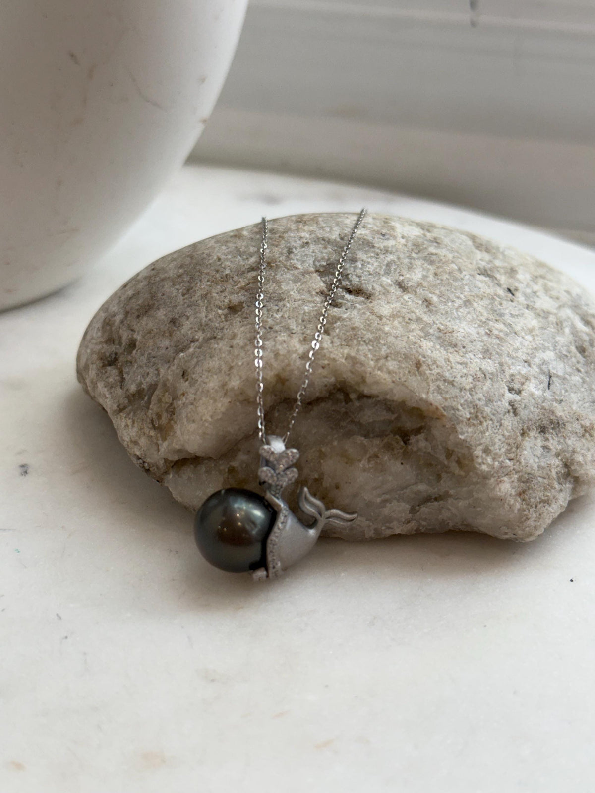 Black platinum pearl pendant with sparkling crystal accents.