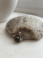 Black platinum pearl pendant with sparkling crystal accents.