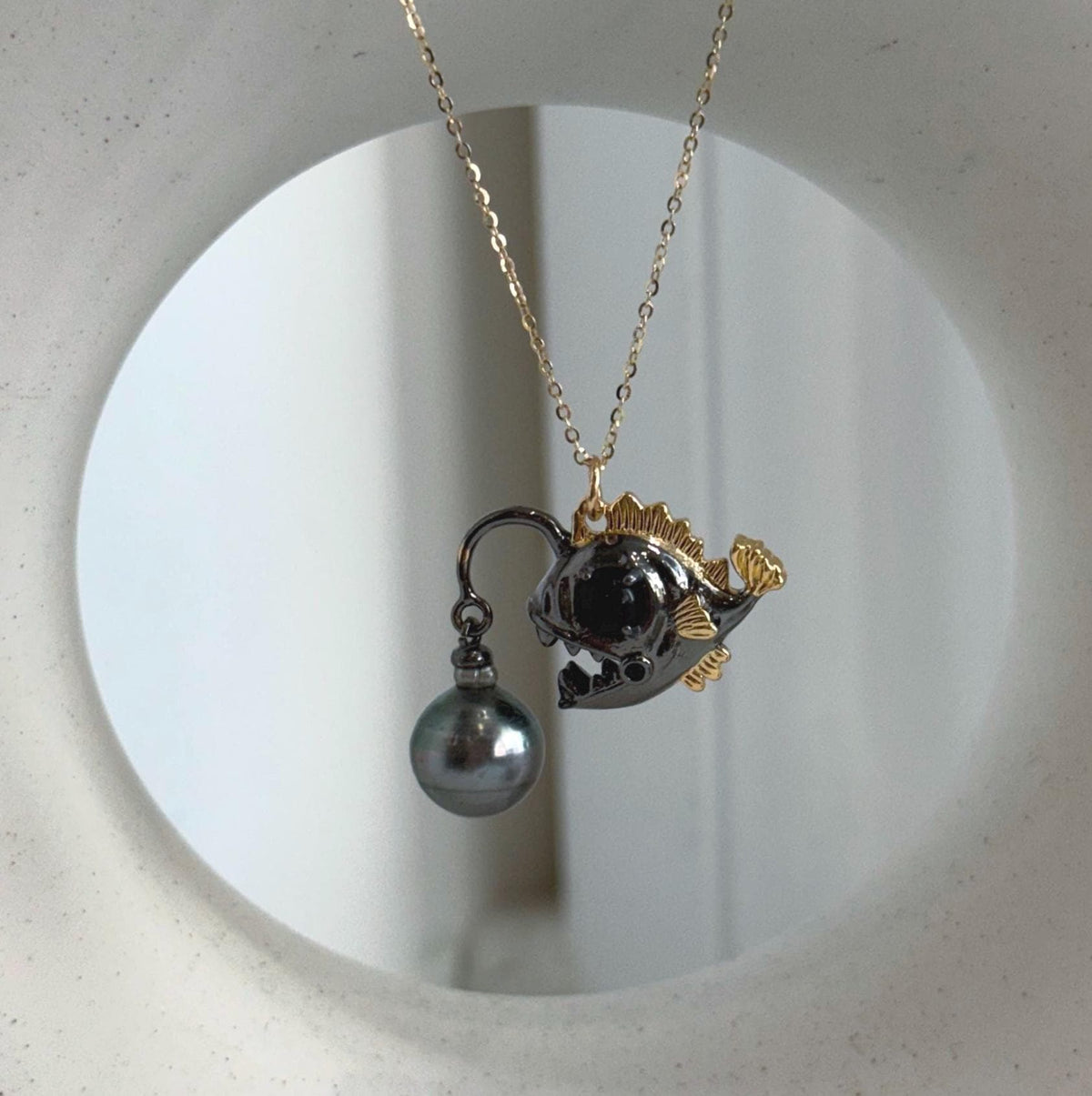 Tahitian pearl necklace with a two-tone anglerfish pendant.