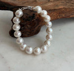 White Edison pearl bracelet showcasing reflective pearl surfaces.