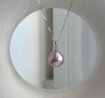 Edison pearl pendant with mauve pink tones and reflective luster.