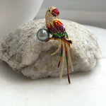 Colorful bird brooch pendant featuring enamel decoration and gold-tone details.