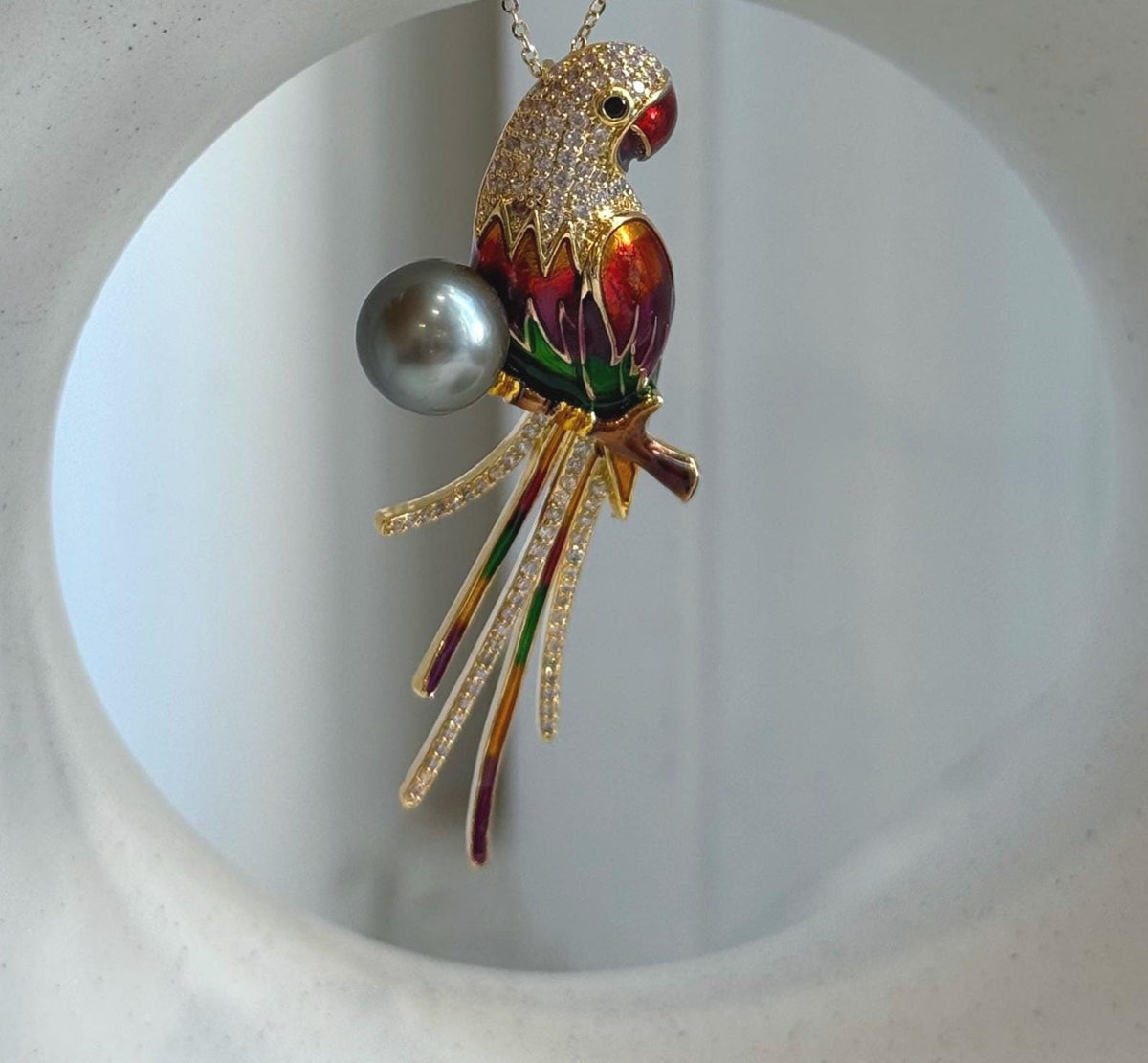 Parrot pendant featuring multicolor enamel and a genuine Tahitian pearl.