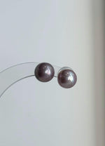 Matching pearl pendant and earrings with luminous reflections.