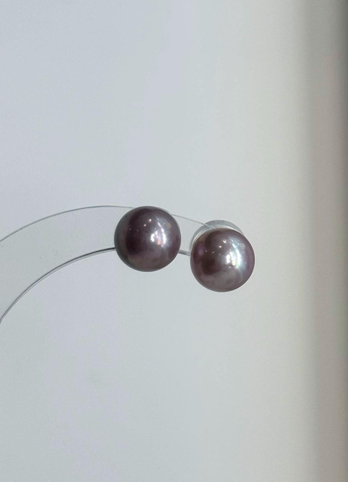 Matching pearl pendant and earrings with luminous reflections.