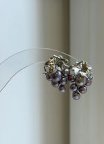 Lustrous freshwater keshi pearls arranged in delicate grape clusters.