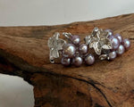 Lustrous freshwater keshi pearls arranged in delicate grape clusters.