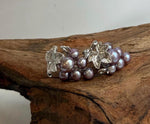 S925 silver earrings featuring genuine purple and green freshwater pearls.