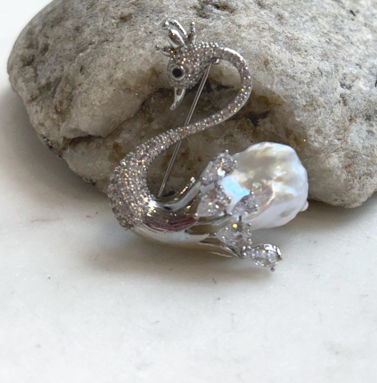 White baroque pearl swan brooch pendant with sparkling crystal accents.
