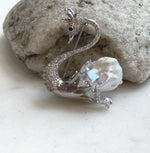 White baroque pearl swan brooch pendant with sparkling crystal accents.