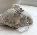 White baroque pearl floral brooch with crystal-accented silver-tone vines.