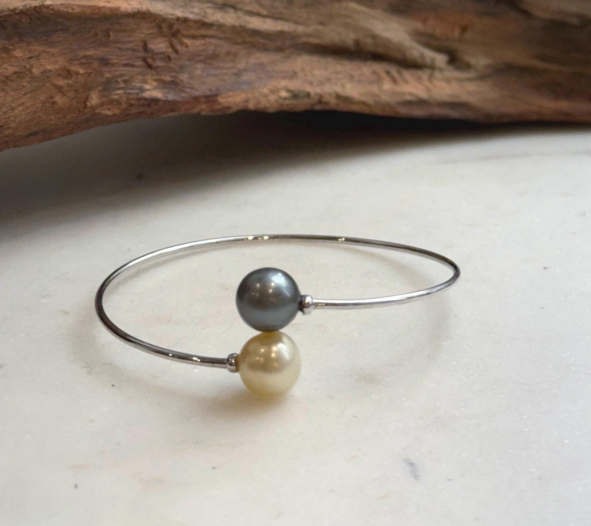 Elegant ocean pearl open bracelet with a delicate sterling silver setting.