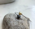 Minimalist sterling silver open bangle featuring two reflective ocean pearls.