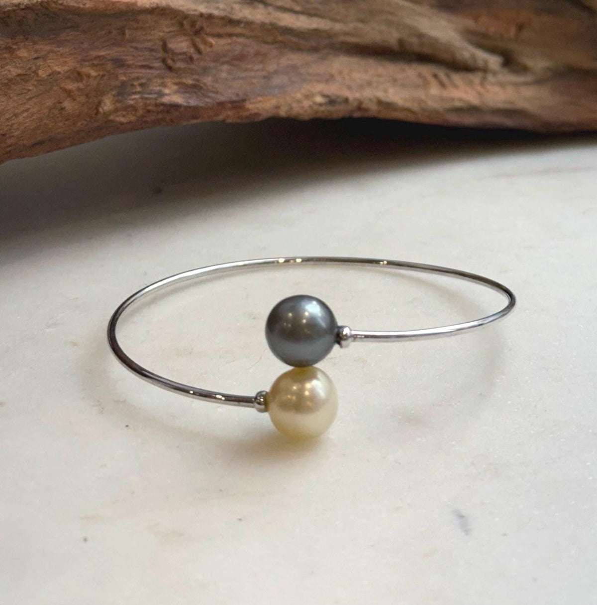 S925 sterling silver open bangle with champagne gold and platinum gray ocean pearls.