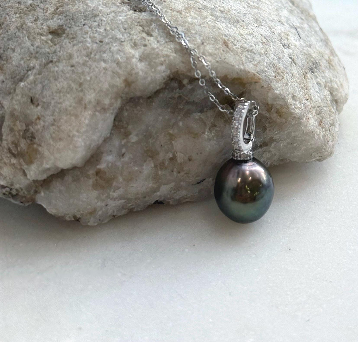 Genuine Tahitian pearl pendant combining peacock green color with bright sterling silver.