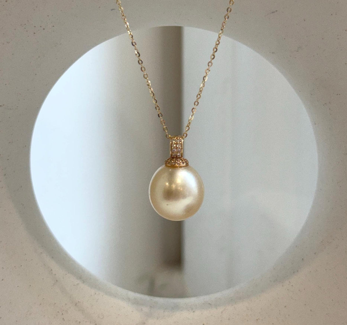 Golden South Sea pearl with a champagne hue and reflective sheen.