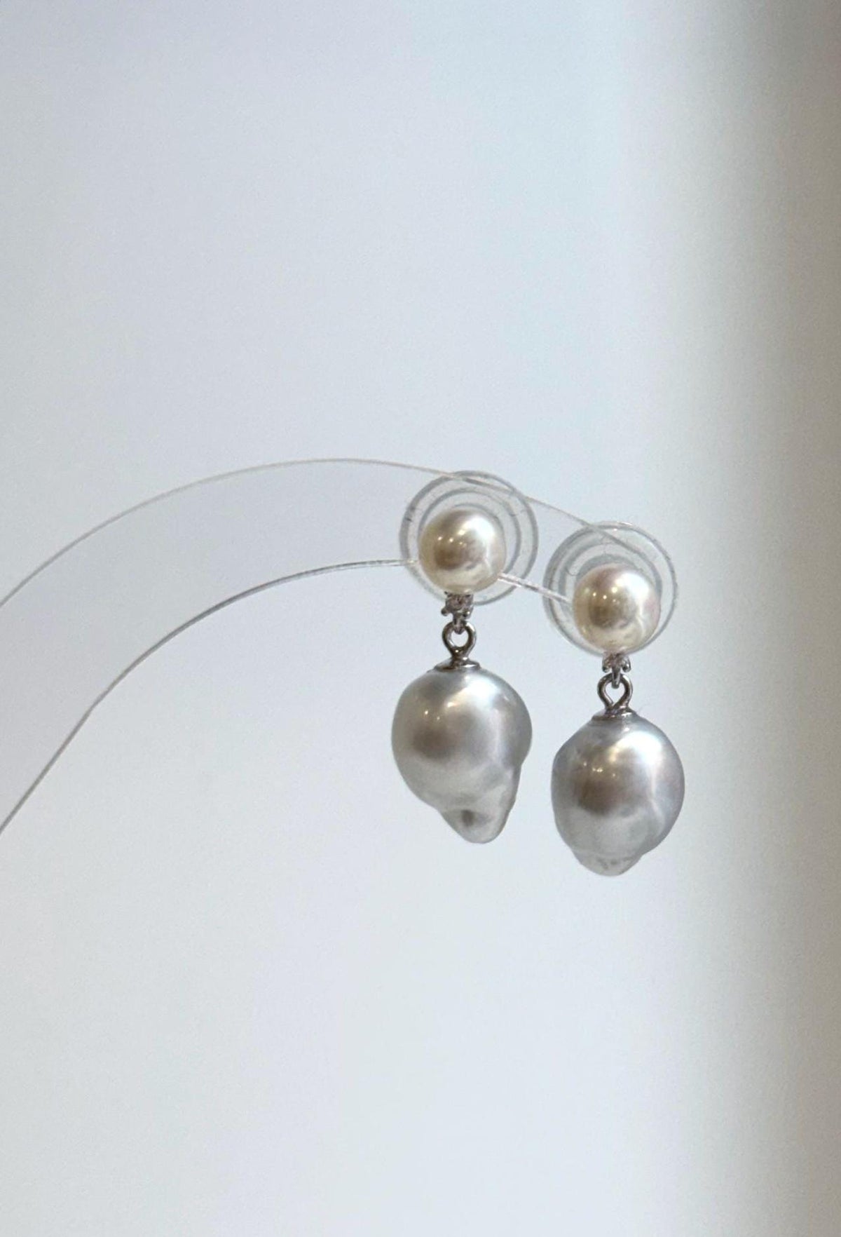 Ivory white pearl studs with dangling silver baroque pearls.