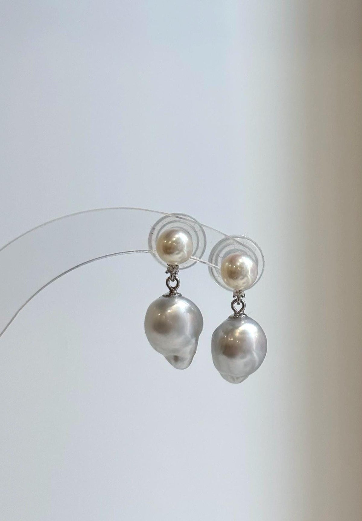 Round ivory white pearls above irregular silver pearl drops.
