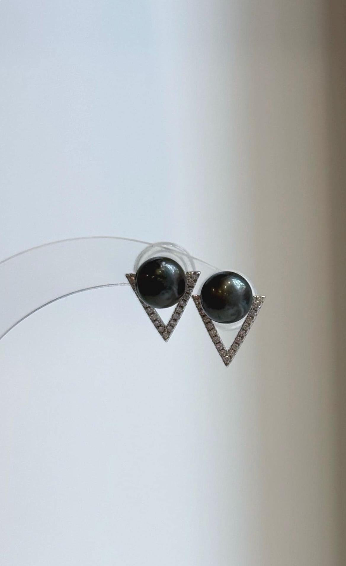 Dark green pearls framed by sparkling V-shaped sterling silver settings.