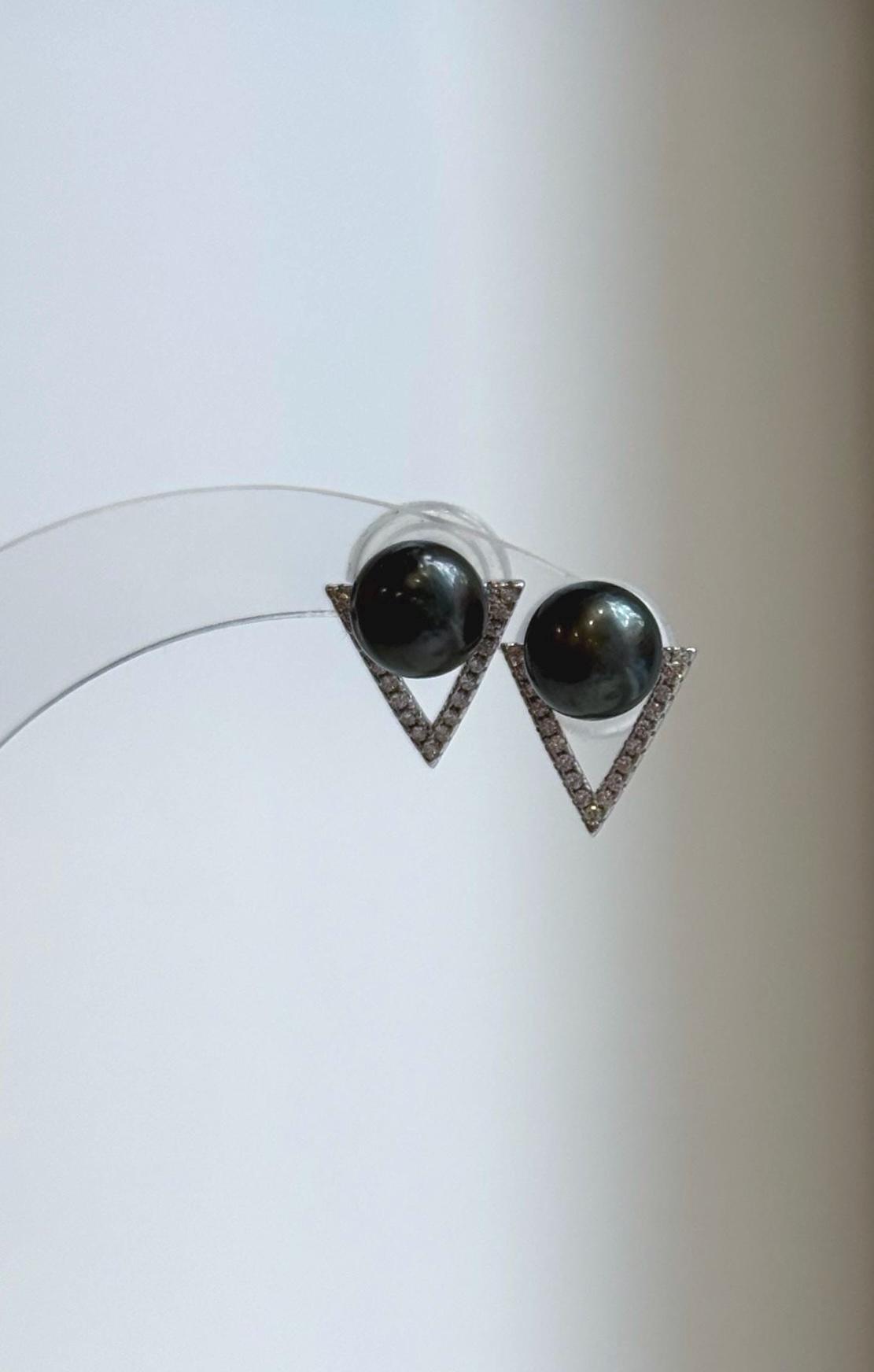 Geometric pearl stud earrings with sparkling triangular silver frames.