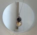 Mirror-luster double pearl pendant with sterling silver settings.