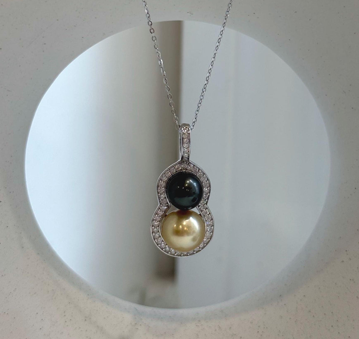Mirror-luster double pearl pendant with sterling silver settings.