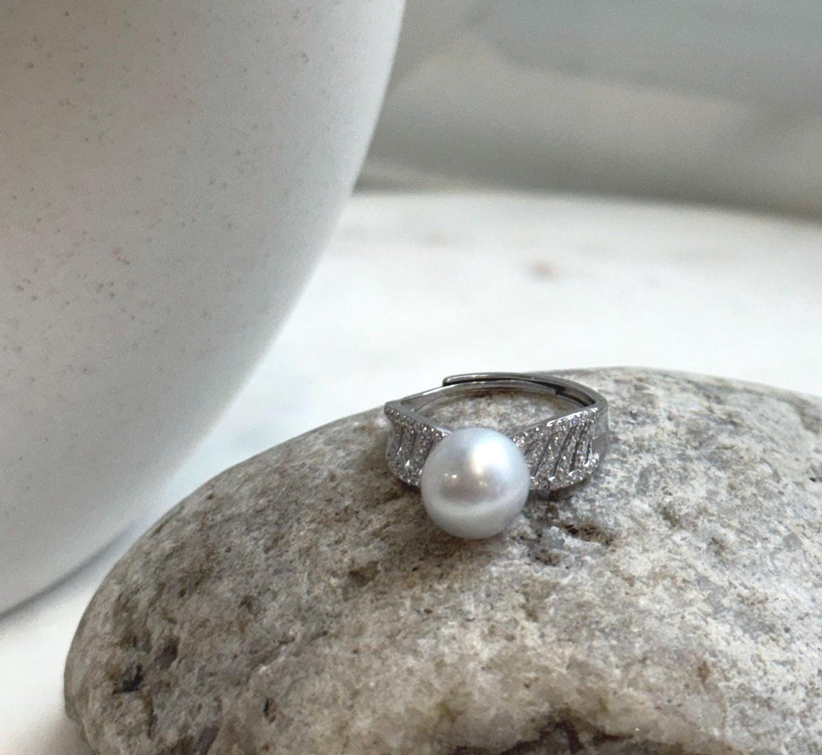 Lustrous white Australian saltwater pearl centered on a decorative sterling silver ring.