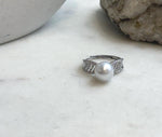 Australian white South Sea pearl ring resting on a clear bag with handwritten measurements.