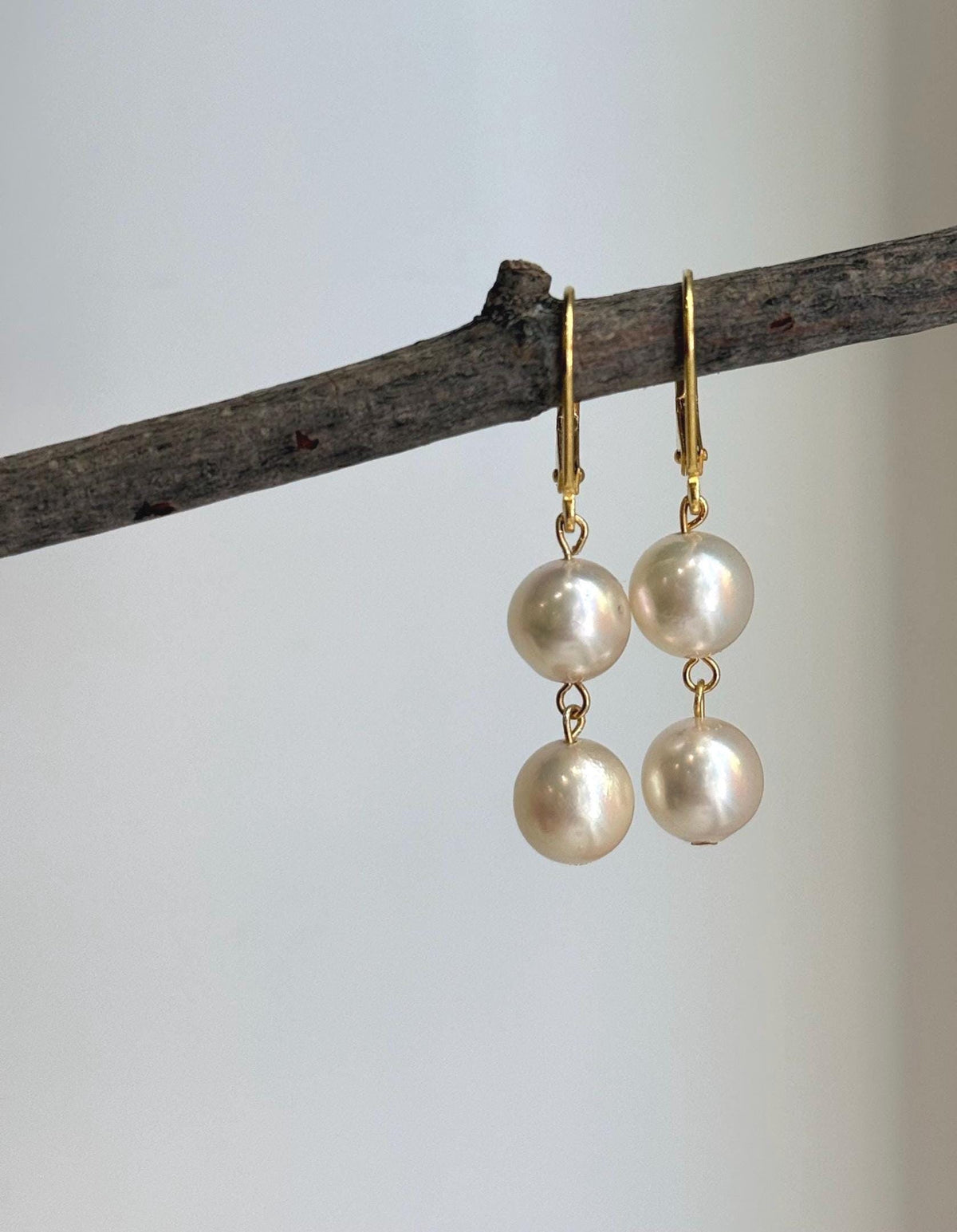 Double Akoya pearl earrings featuring two lustrous ivory pearls on each earring.