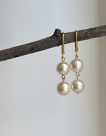 Double Akoya pearl earrings featuring two lustrous ivory pearls on each earring.