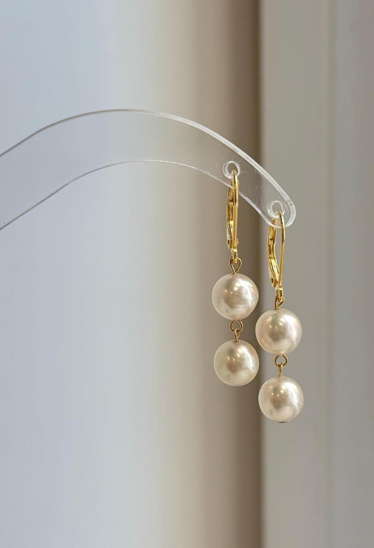 Four ivory Akoya pearls arranged in matching double pearl drops.