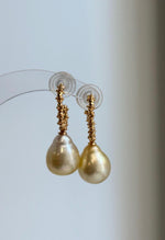 Mirror-luster golden pearl drops hanging from S925 silver hooks.