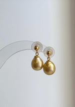 Teardrop golden pearls suspended from S925 sterling silver posts.