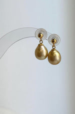 Lustrous golden pearl drops with delicate gold-tone caps.